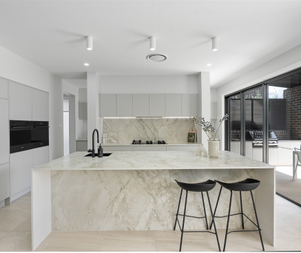 Modern kitchen with marble island bench and luxurious finishes in the Ascot Double-Storey home by King Homes NSW.