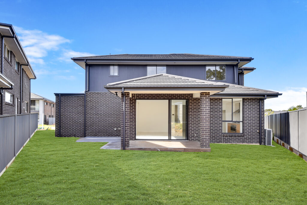 A modern double-storey brick home with a welcoming entrance and a spacious double garage, designed for investment and family living.